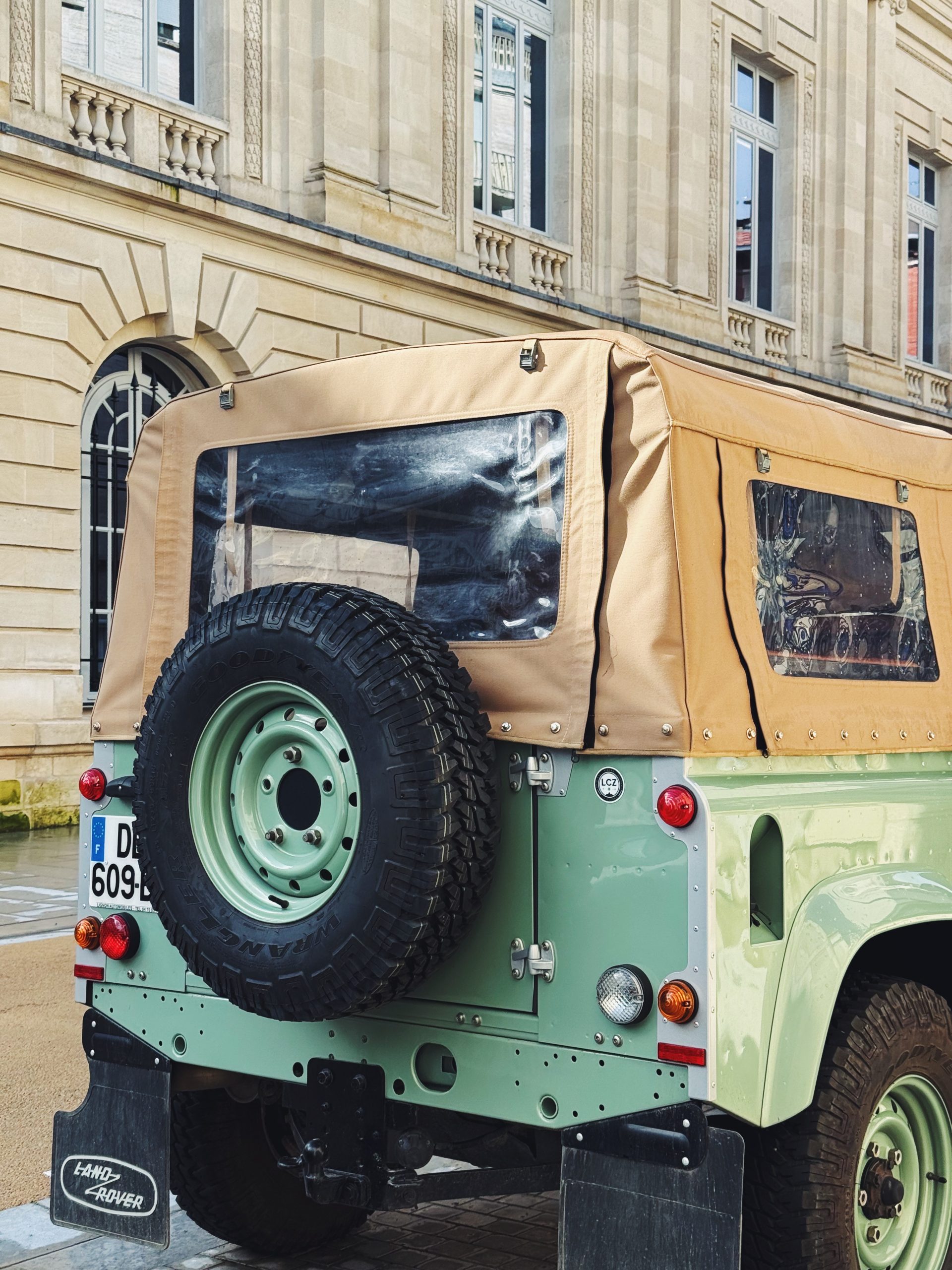 Red Land Rover Defender decorated with Christmas lights — the perfect festive gift inspiration for defender enthusiasts