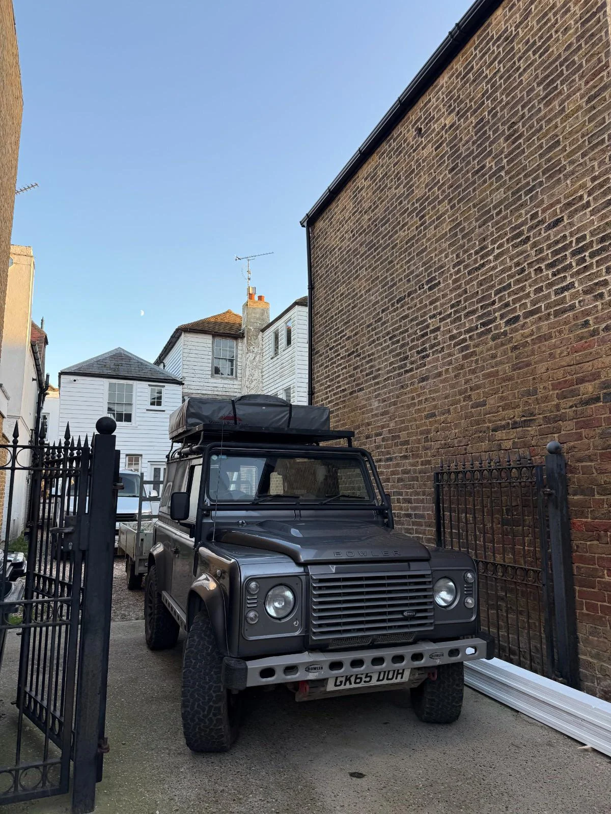 Classic Land Rover Defender 90 in green parked outside Norwich Cathedral — the kind of Defender that catches every buyer eye