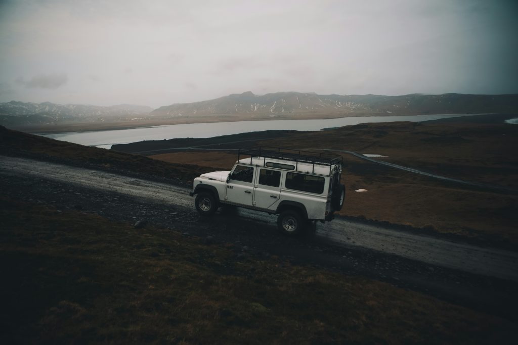 Land Rover Defender off road in rugged mountain landscape